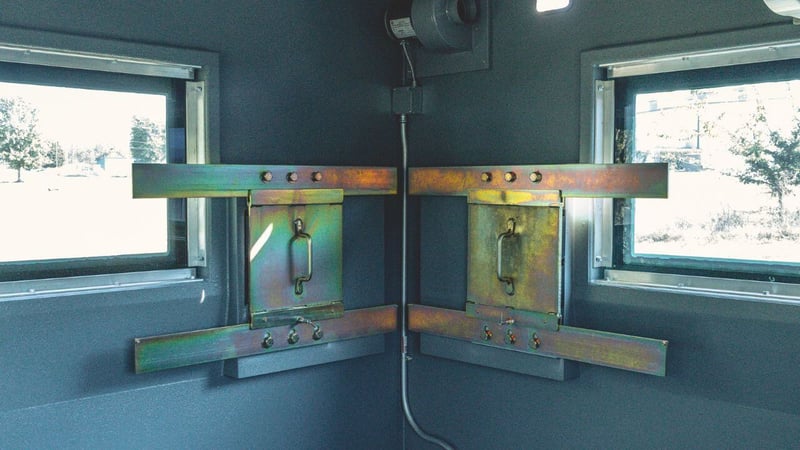 two sliding gun ports mounted on metal frames