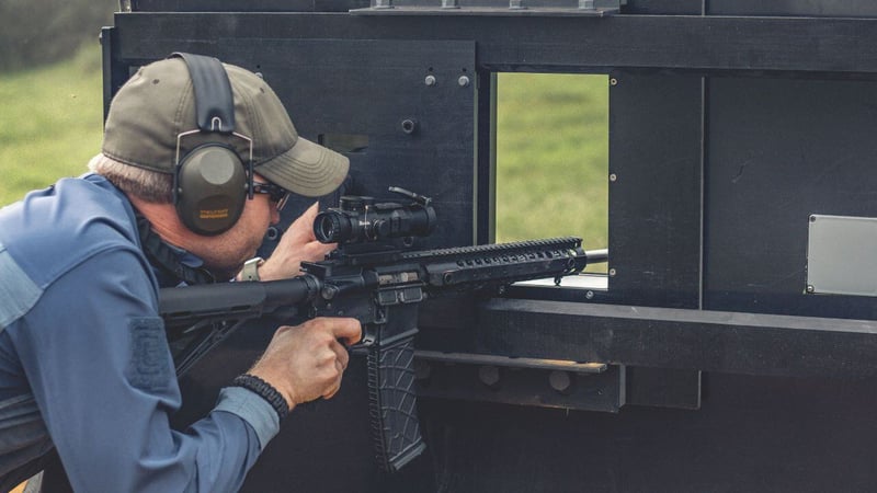 using a rifle through a gun port during a training exercise